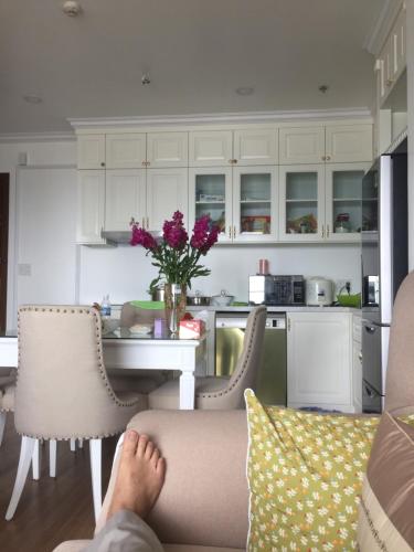 a person sitting on a couch in a kitchen at S1-The Sapphire 05A11A - 2sleep, 2wc in Ha Long