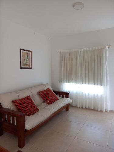 a living room with a couch and a window at La Juana in Almafuerte