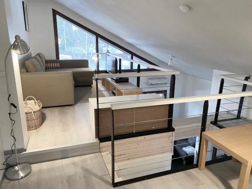 een woonkamer met een trap met een bank en een tafel bij Tahkonloft in Kuopio