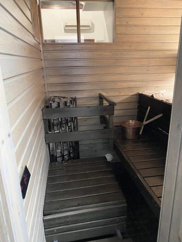 a wooden sauna with a wooden bench in it at Tahkonloft in Tahkovuori
