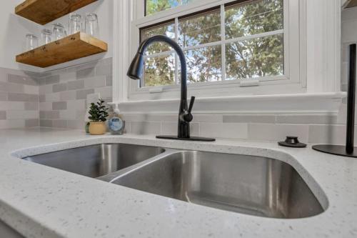 a kitchen with a sink and a window at Housepitality - Electric Ave - 3 BDR and Hot Tub in Westerville