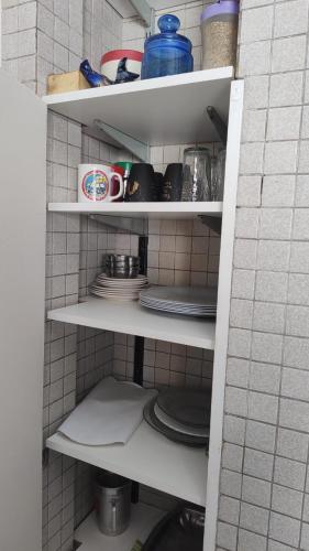 a shelf with plates and cups and dishes on it at Departamento en excelente área in Villa Marini