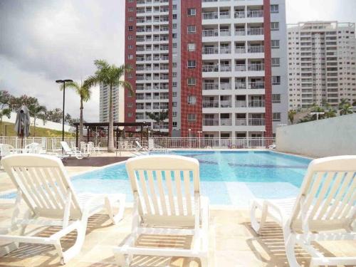 a group of chairs sitting next to a swimming pool at Vista Rio - A vista é Incrível in Manaus