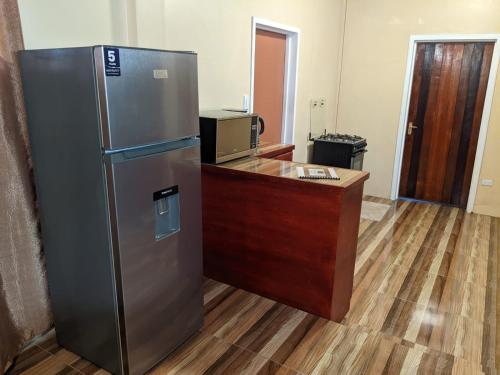 a kitchen with a stainless steel refrigerator and a desk at Destination Hope in Georgetown