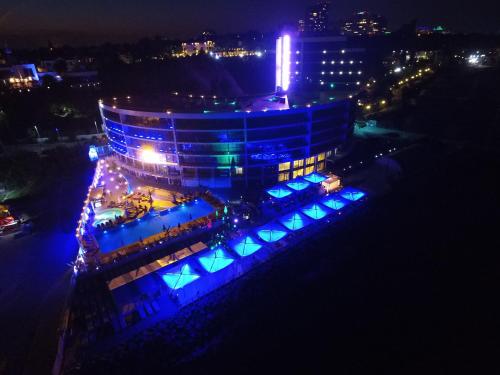 a building with blue lights on it at night at Maristella Marine Residence in Odesa