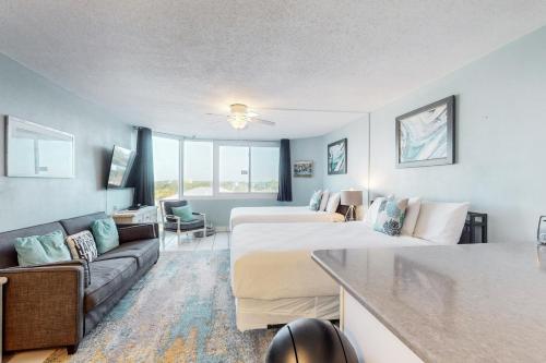 a hotel room with two beds and a couch at Top of the Gulf 708 in Panama City Beach