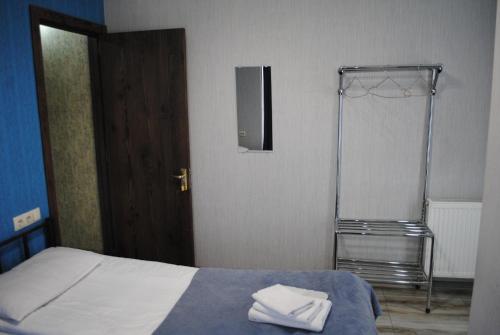 a bedroom with a bed with two towels on it at Sweet home in Tbilisi City
