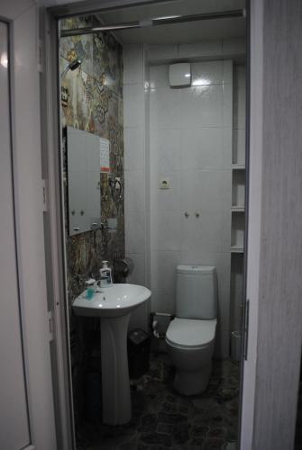 a bathroom with a toilet and a sink at Sweet home in Tbilisi City