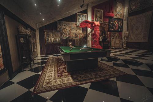 a room with a pool table in a room with paintings at Casa Malca in Tulum