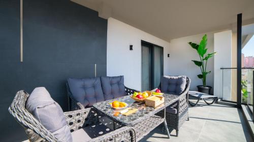 a balcony with a table with fruit on it at Stile Suite Marine Hotel in Antalya