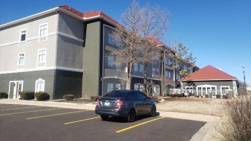 a car parked in a parking lot in front of a building at La Quinta by Wyndham Shawnee in Shawnee