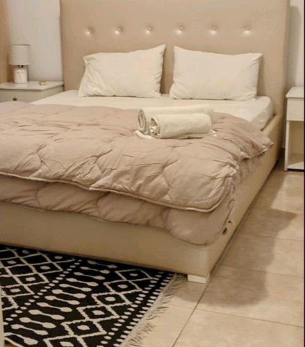 a bed with a cat sitting on top of it at Lion Apartment in Limenas
