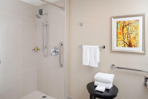 a bathroom with a shower with a glass door at DoubleTree by Hilton Kansas City - Overland Park in Overland Park