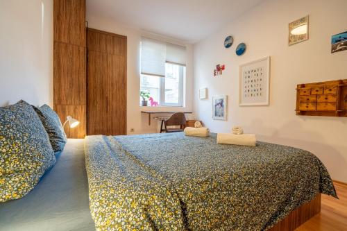 a bedroom with a large bed and a window at 1 Bedroom Natural Condo in Sofia