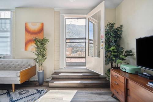 a living room with a couch and a window at THE CARRICK in Bisbee