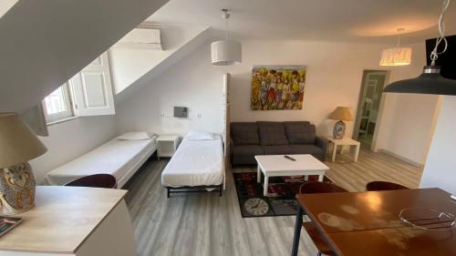 a small living room with a couch and a table at Apartamentos Turisticos Queluz in Queluz