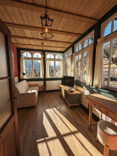 a living room with a pool table and windows at Gasthof Eggwirt in Ultimo