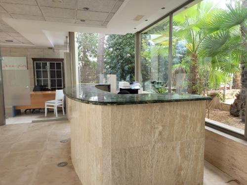 a lobby with a counter with a large window at Paraiso Beach by Hoteles Centric -Adult Only in Es Cana