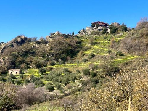 a house on the side of a hill at Vista Alcantara - Wellness Mountain-Top Retreat in Motta Camastra