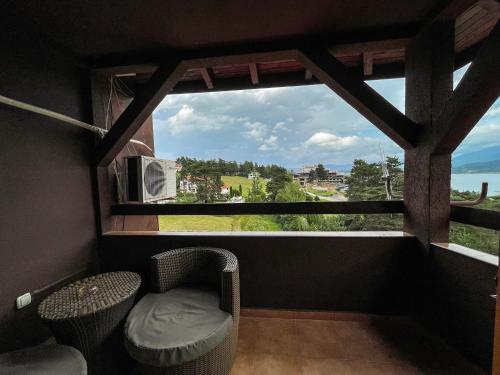 a room with a window with a chair and a table at Katalina SPA Resort in Tsigov Chark