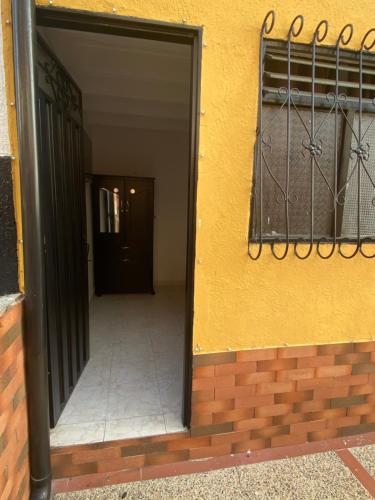 an open door to a building with a balcony at Apartaestudio Bellapalma Socorro Calle 16a # 7-37 in Socorro