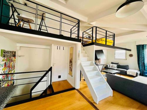 un salon avec un escalier menant à une mezzanine dans l'établissement Grand Appartement T3 Standing en Hypercentre, à Toulouse