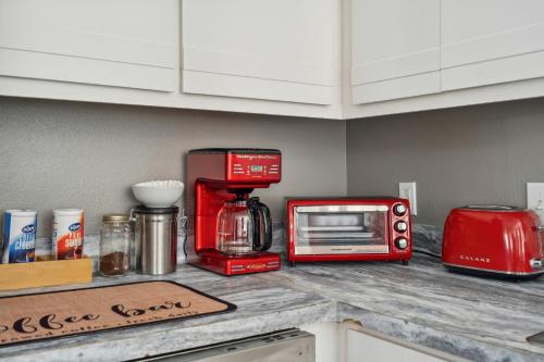 a kitchen counter with a red coffee maker and a toaster at THE CARRICK in Bisbee