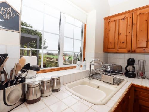 a kitchen with a sink and a window at The View in Faversham