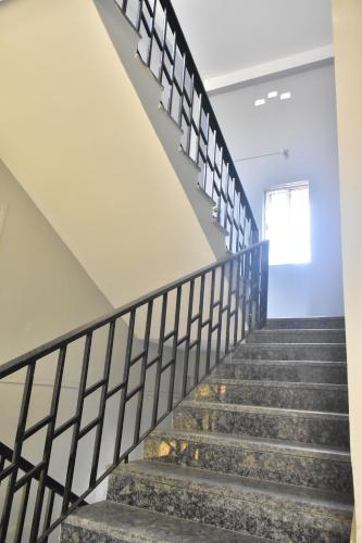 a set of stairs in a building with a stair railing at Urban Suites Silpukhuri in Guwahati