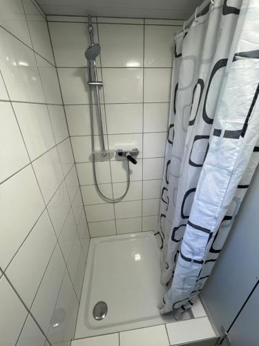 a bathroom with a shower with a shower curtain at Bristenblick in Fluelen