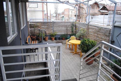 a balcony with a table and chairs on a building at Sweet home in Tbilisi City