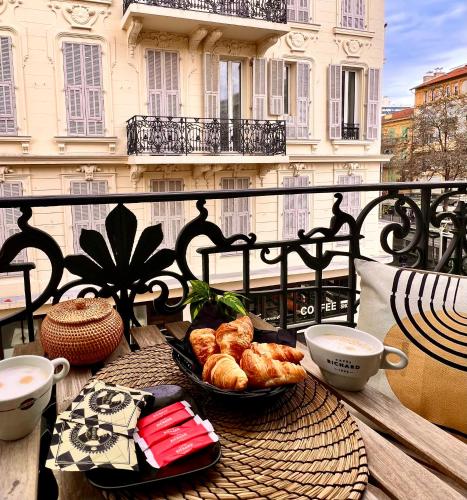 a table with a tray of pastries on a balcony at LIBERATION CENTER - PRIVATE Balcony - 24&7 RECEPTION - LUGGAGE STORAGE in Nice