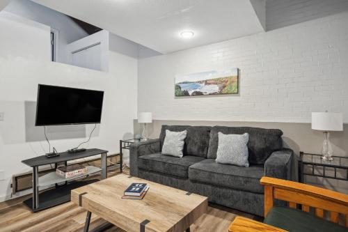 a living room with a couch and a flat screen tv at THE CARRICK in Bisbee