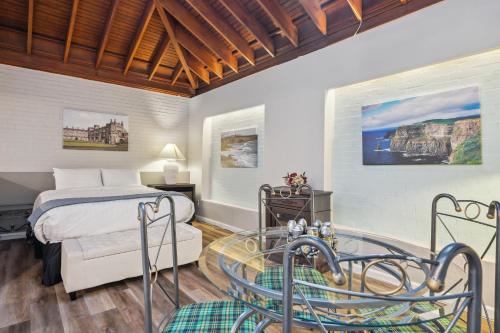 a bedroom with a bed and a glass table at THE CARRICK in Bisbee