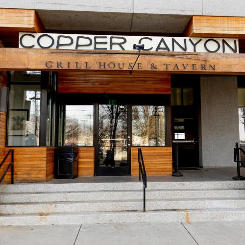 a building with a sign that reads copper canyon grill house and tavern at Radisson Hotel Salt Lake City Downtown in Salt Lake City