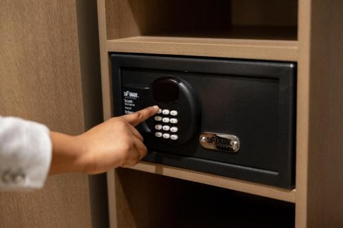 a person is pressing a button on a microwave oven at Radisson Hotel Salt Lake City Downtown in Salt Lake City