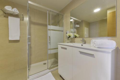 a bathroom with a white sink and a shower at Hotel Amazonas in El Arenal