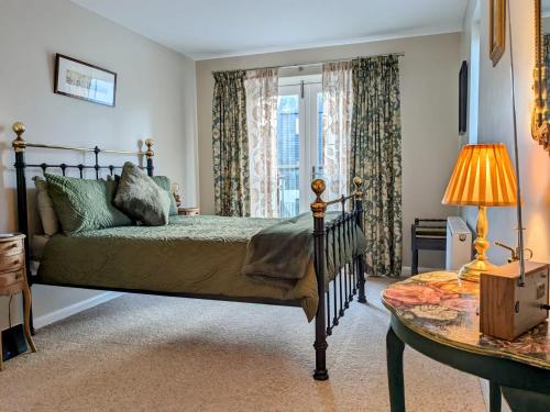 特維德上游的貝里克的住宿－18 Mill Wharf Apartment，一间卧室设有一张床、一个窗口和一张桌子
