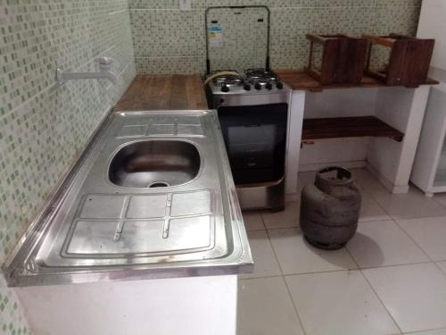 a kitchen with a sink in the middle of a kitchen at Jeri laguna chalés paraiso in Jijoca de Jericoacoara