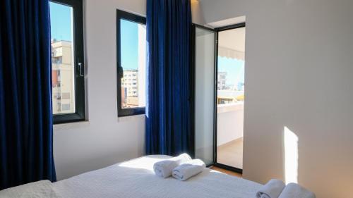 una camera da letto con un letto e una grande finestra di 2E Center Apartment a Tirana