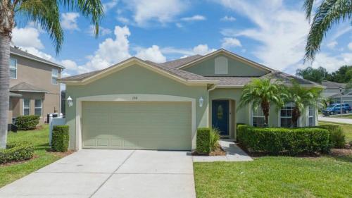 a house with a garage in a yard with palm trees at 150 Stunning 4BD Perfect for Your Vacation in Davenport