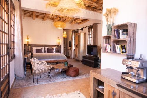 a large bedroom with a bed and a table at Eden Boutique Hotel in Tamellalt