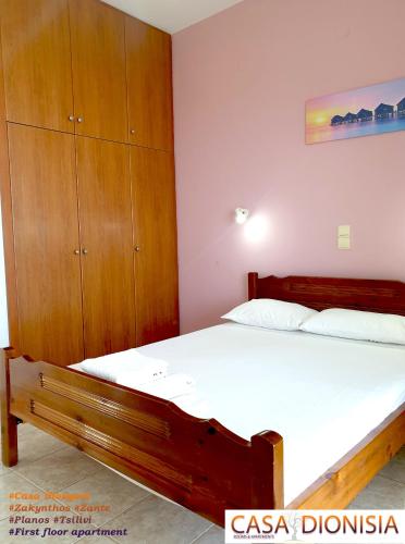 a bedroom with a bed and a wooden cabinet at Casa Dyonisia Tsilivi in Plános