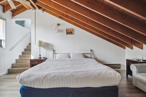 a bedroom with a large bed and a staircase at THE CARRICK in Bisbee