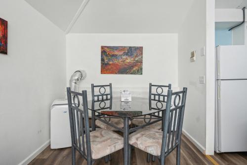 a dining room table with two chairs and a refrigerator at THE CARRICK in Bisbee