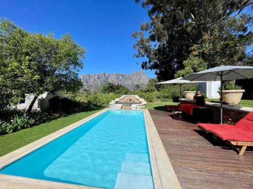 a swimming pool in the backyard of a house at Banhoek Corner Guesthouse in Stellenbosch