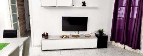 a living room with a tv on a white wall at Golden Ambient Apartment in Chirivella