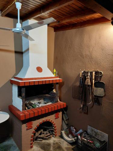 a brick oven in a kitchen with a ceiling at Villa seniorita Annita in Nikiti