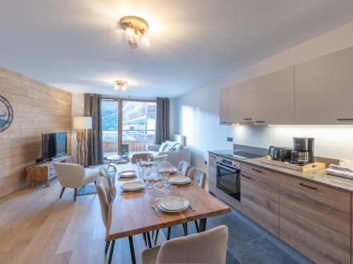 une cuisine et une salle à manger avec une table et des chaises dans l'établissement Appartement neuf, spacieux, proche pistes et centre, parking et wifi inclus - FR-1-645-61, à Huez