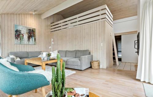 a living room with a couch and a table at Holiday Home Ålevej Ebeltoft I in Ebeltoft